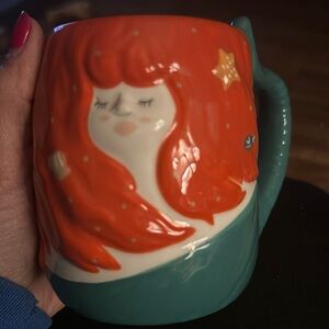 Adorable mermaid mug with cute details.